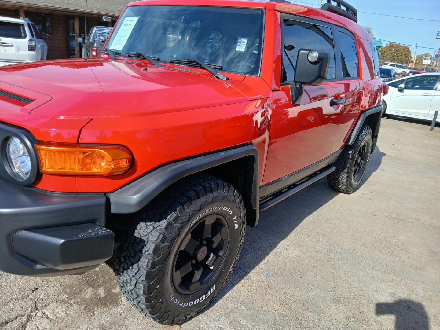 2012 Red Toyota FJ Cruiser 4WD MT (JTEBU4BF7CK) with an 3.4L V6 DOHC 24V engine, 6-Speed Manual transmission, located at 945 E. Jefferson Blvd, Dallas, TX, 75203, (214) 943-7777, 32.752514, -96.811630 - Photo#0