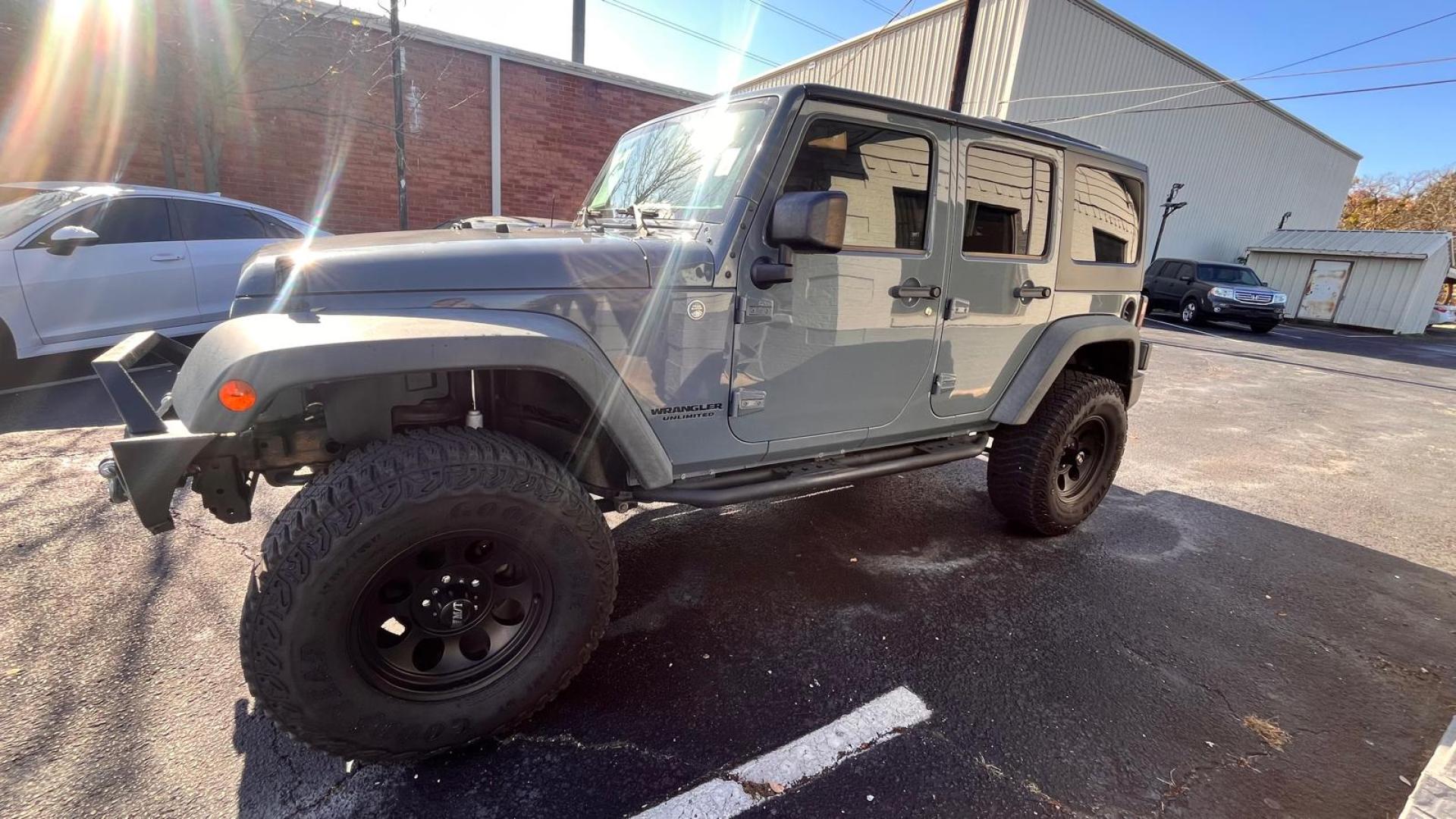 2015 Gray Jeep Wrangler Unlimited Rubicon 4WD (1C4BJWFG4FL) with an 3.6L V6 DOHC 24V FFV engine, located at 945 E. Jefferson Blvd, Dallas, TX, 75203, (214) 943-7777, 32.752514, -96.811630 - Photo#0